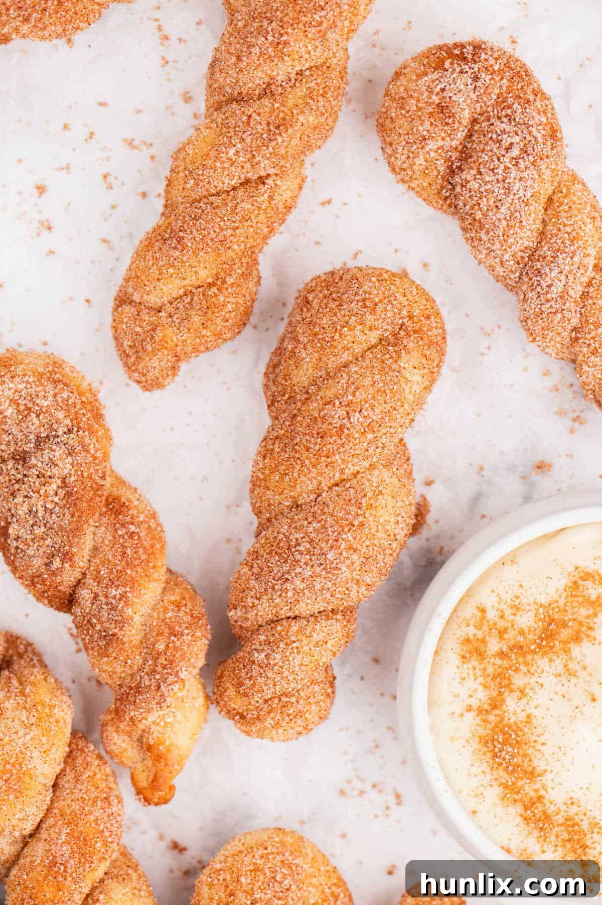 Air fryer cinnamon twists with cream cheese dip, ready to be served.