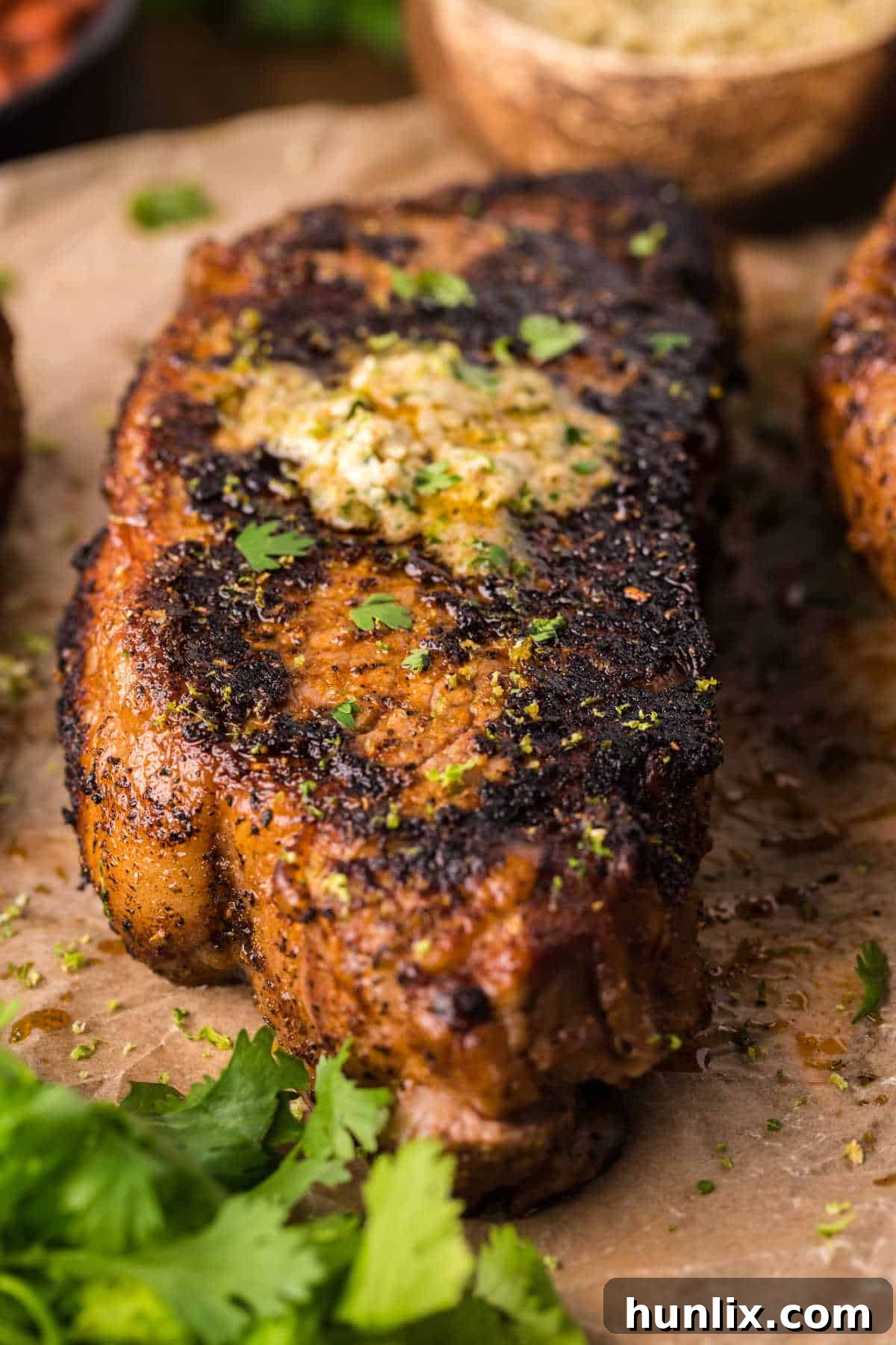 Blackened steak on a piece of parchment paper.