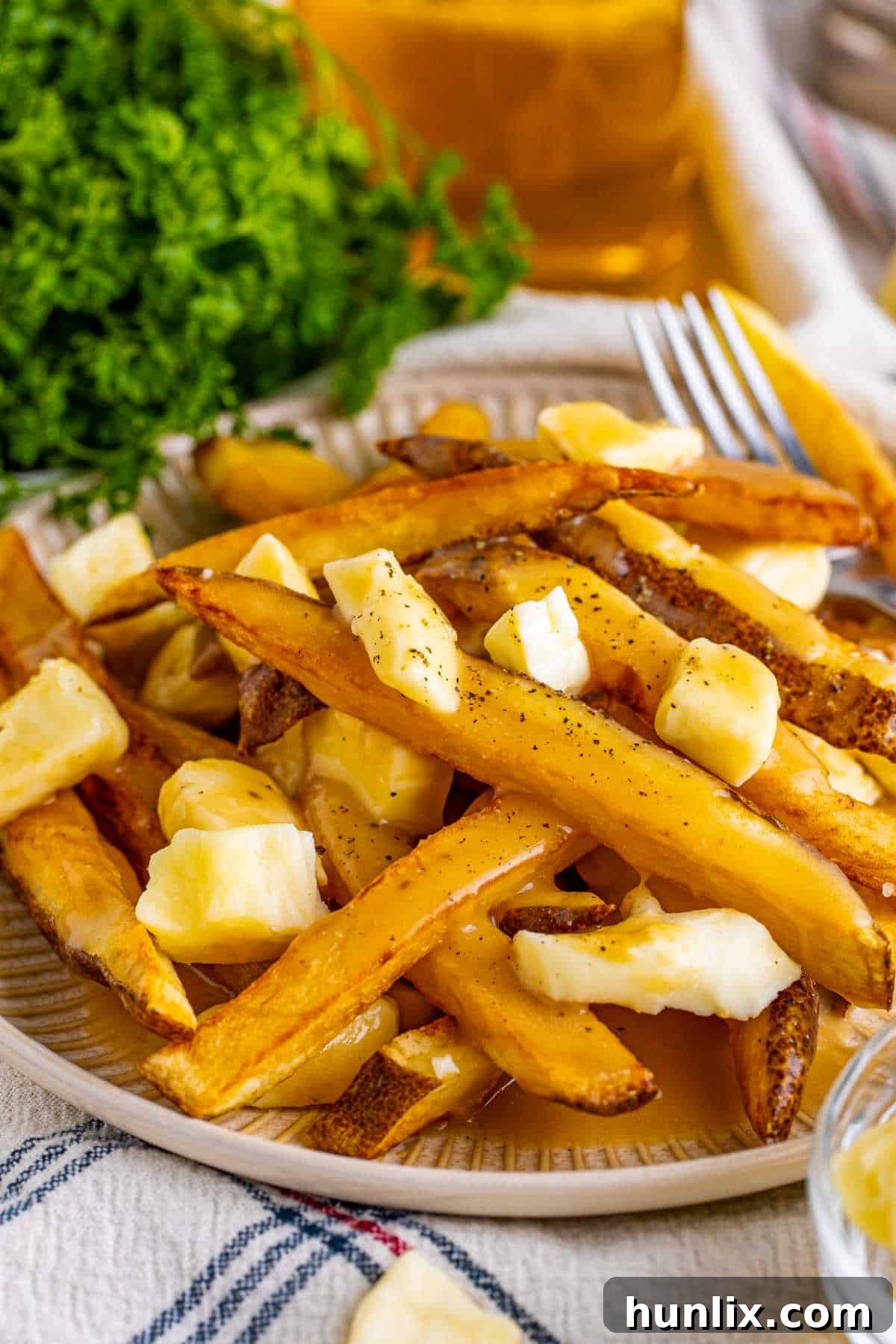 Canada's Iconic Comfort Food 6 A plate of perfectly assembled poutine, with visible crispy fries, melting cheese curds, and rich gravy.