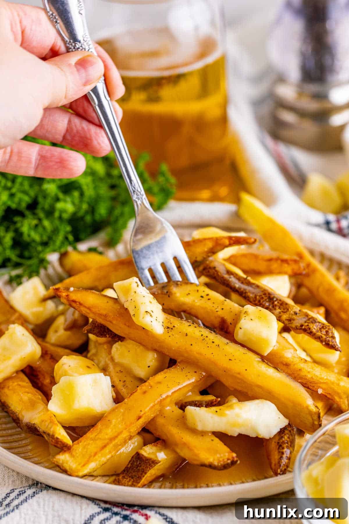 Canada's Iconic Comfort Food 8 A fork lifting a mouthful of poutine, showcasing the melty cheese, gravy, and crispy fries.