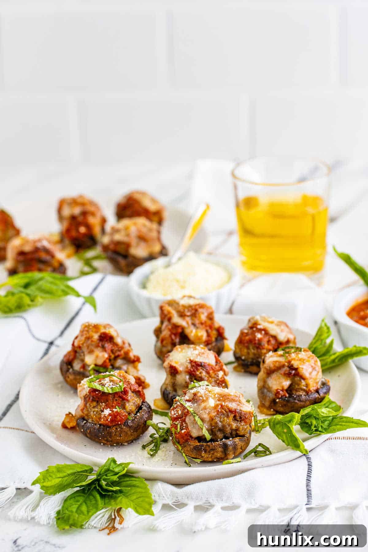 A beautifully arranged plate of golden-brown Meatball Stuffed Mushrooms, ready to serve.