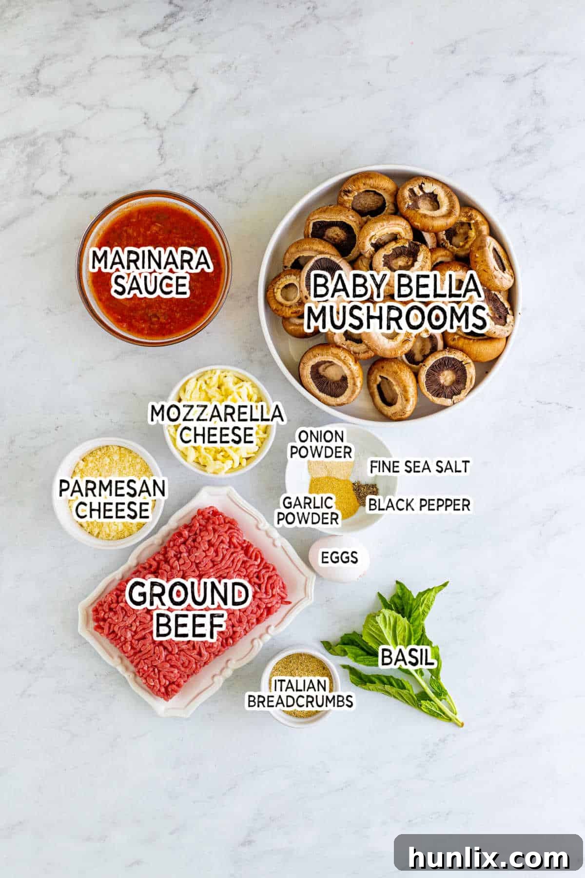 A colorful array of ingredients laid out on a counter, including ground beef, mushrooms, cheese, and spices, ready to make meatball stuffed mushrooms.