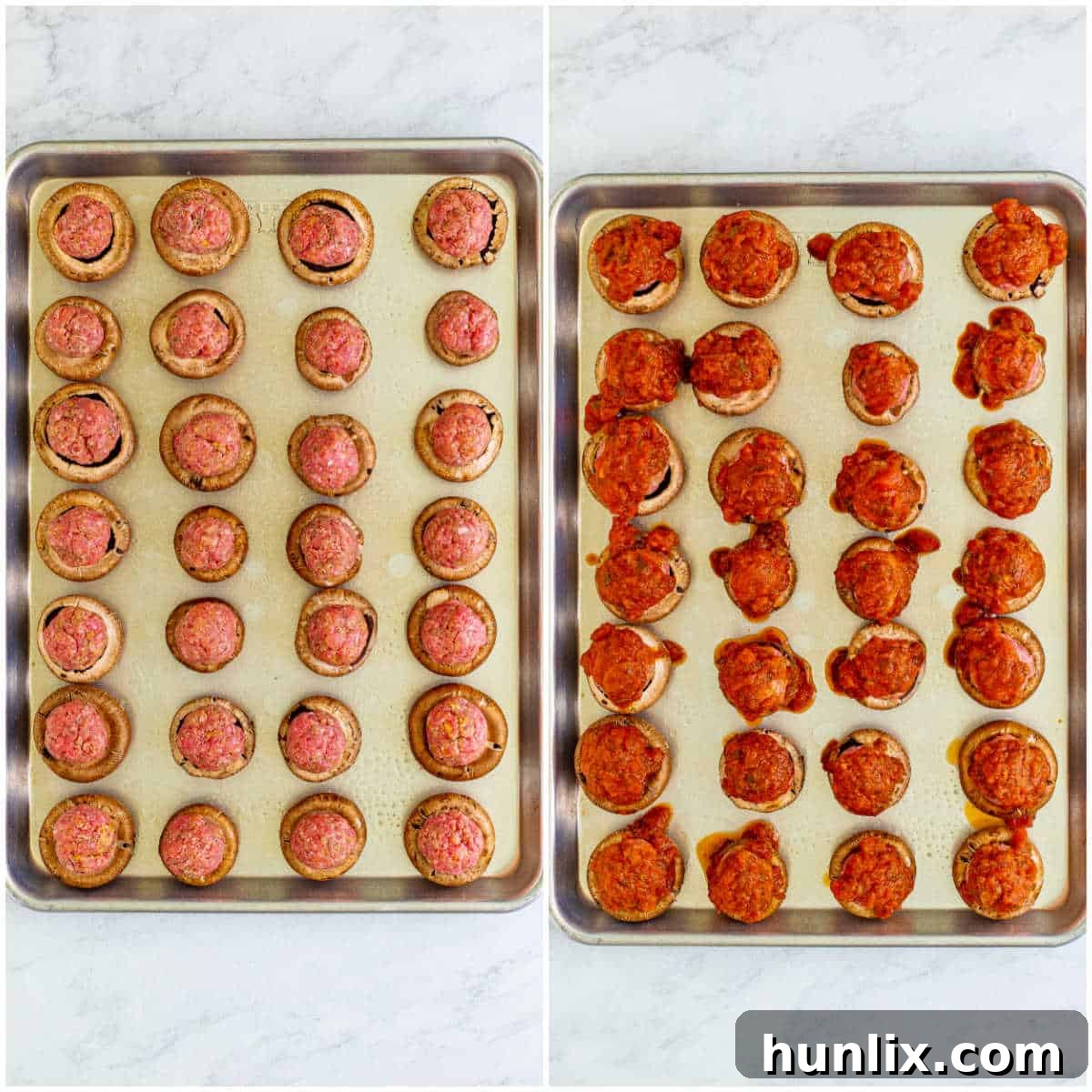 A close-up view of raw meatball stuffed mushrooms on a baking sheet, topped with marinara sauce and ready for the oven.