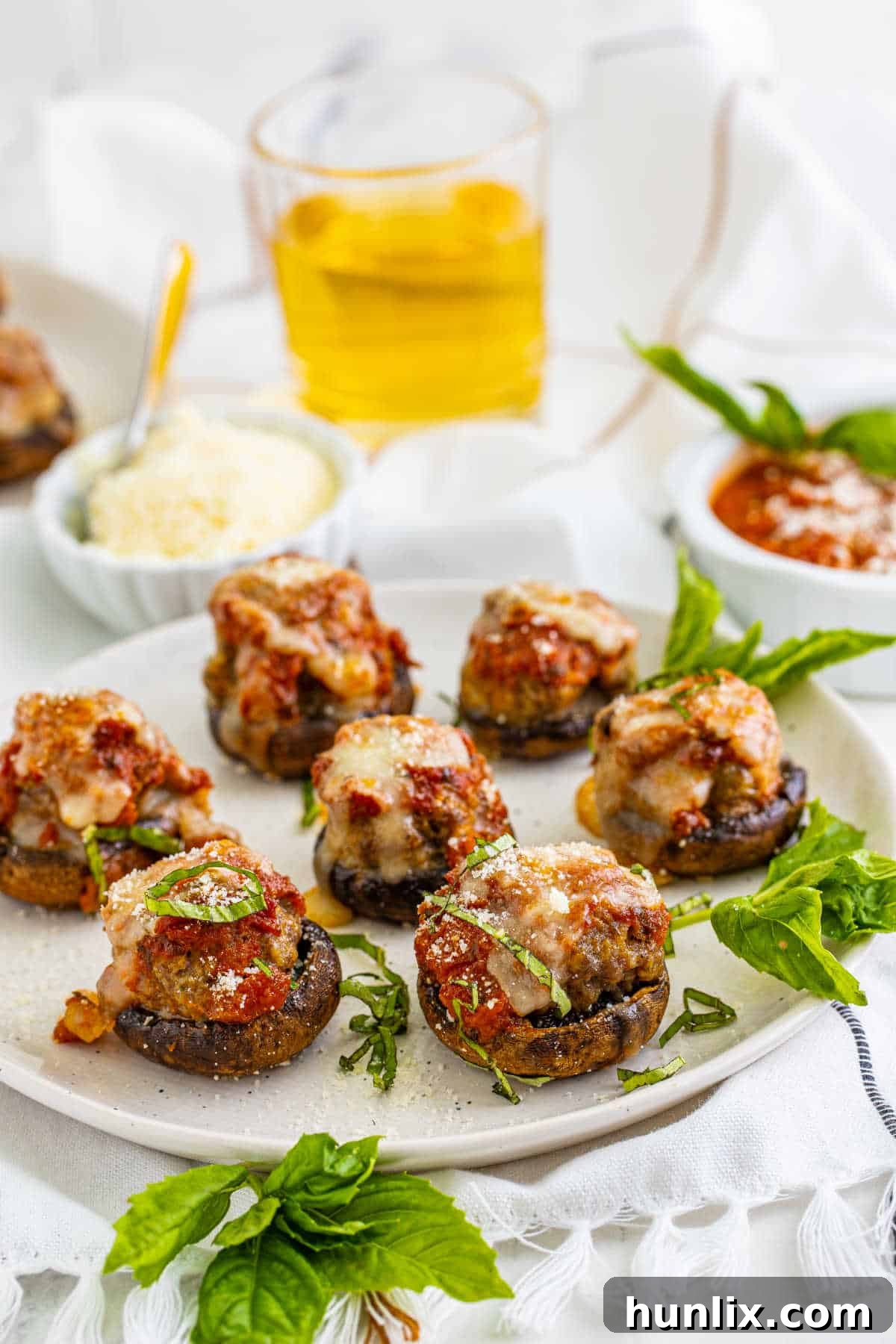 A serving platter adorned with perfectly baked Meatball Stuffed Mushrooms, garnished with fresh herbs, showcasing their appetizer appeal.