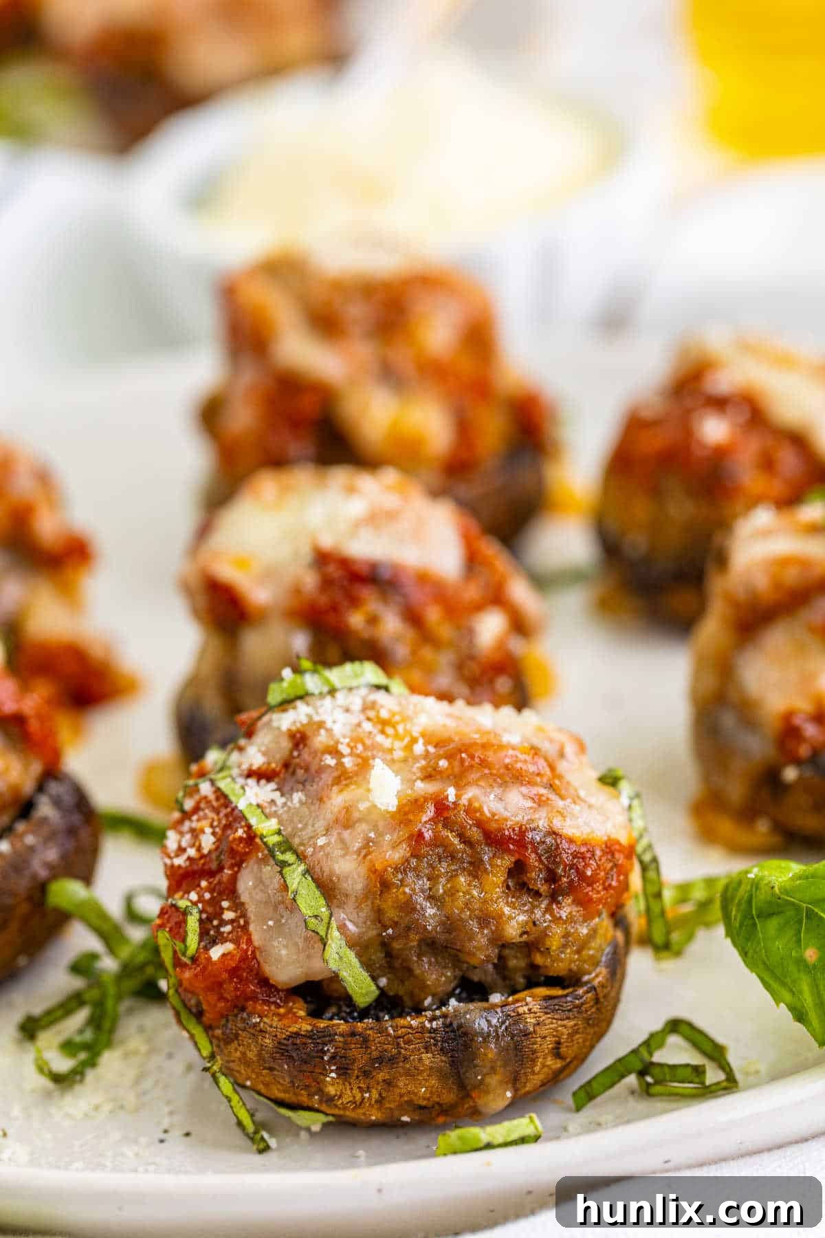 A serving of Meatball Stuffed Mushrooms, perfectly baked with melted cheese, showcasing the delightful blend of ingredients.