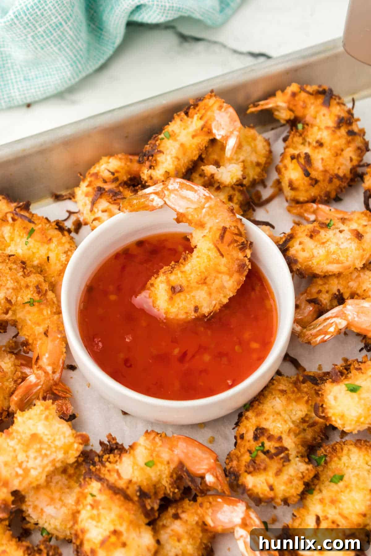 A shrimp in a bowl of dipping sauce.