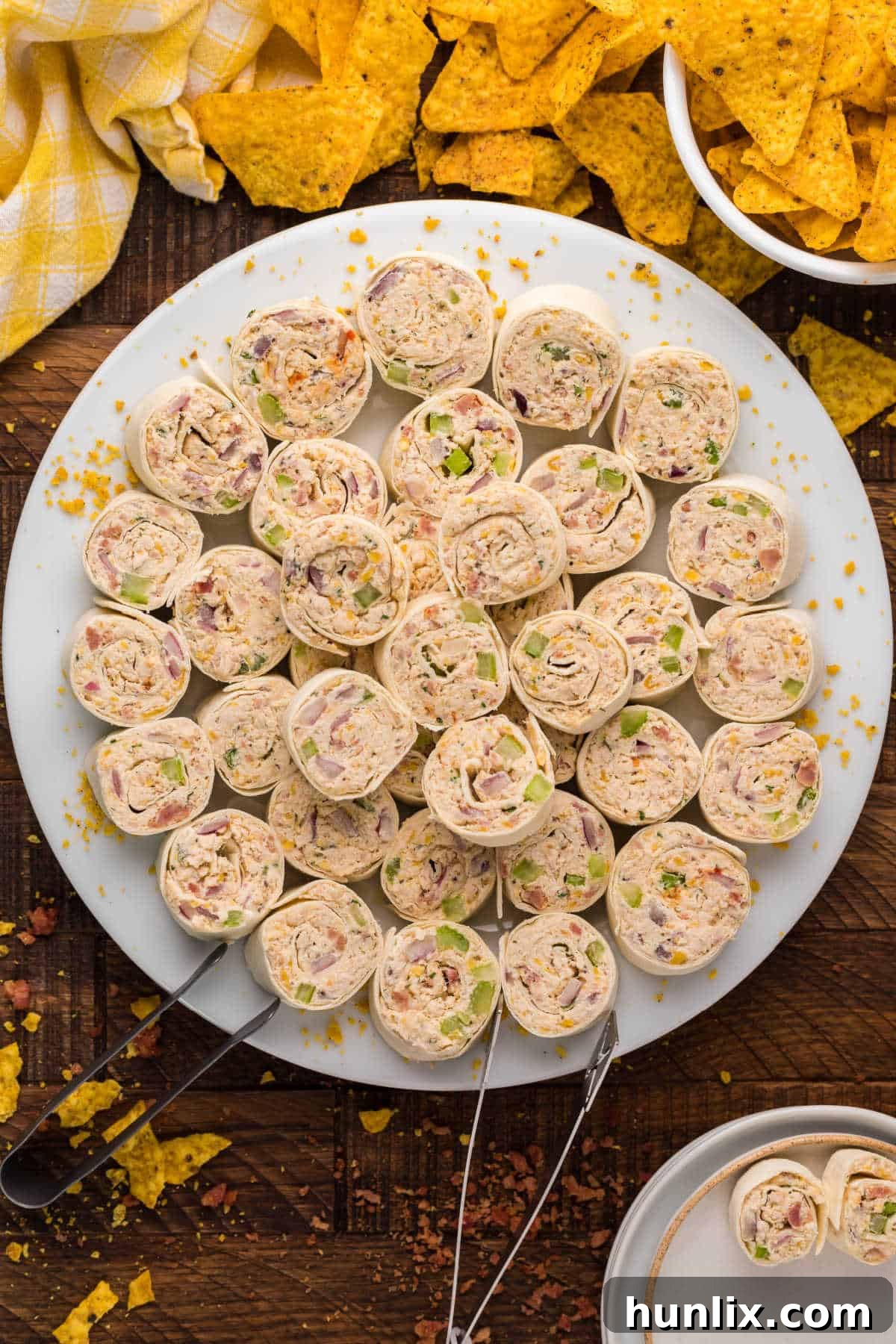 A vibrant platter of freshly cut Chicken Pinwheels, showcasing their appealing spiral shape and delicious filling.