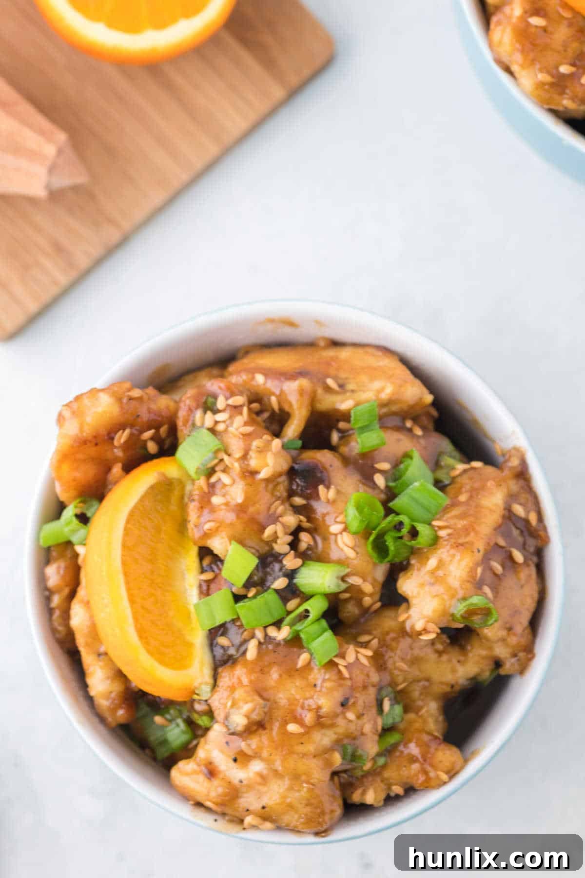 A beautifully presented bowl of orange chicken, invitingly placed for serving.