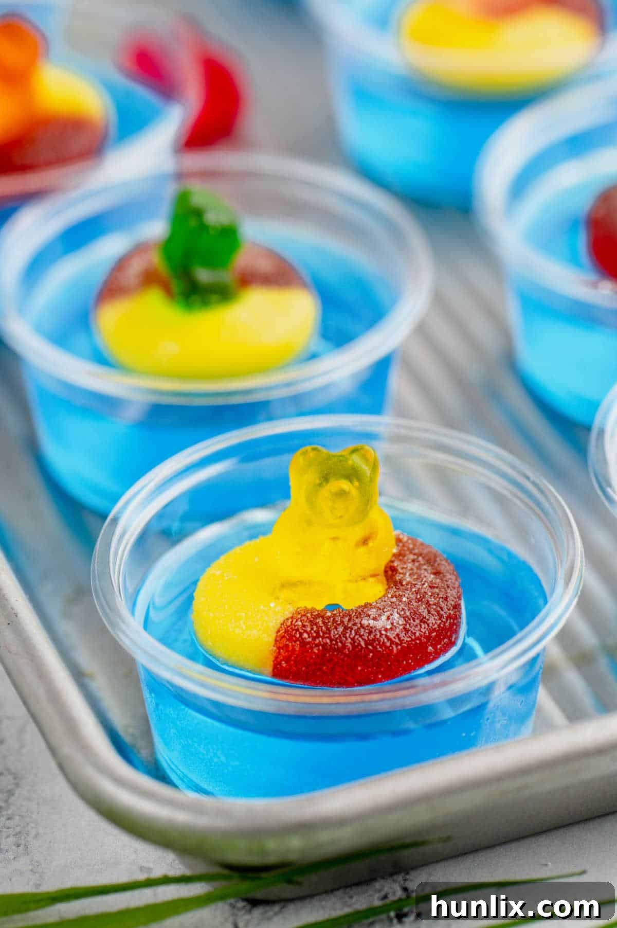 Pool party jello shots on a baking tray, ready to be served at a summer gathering.