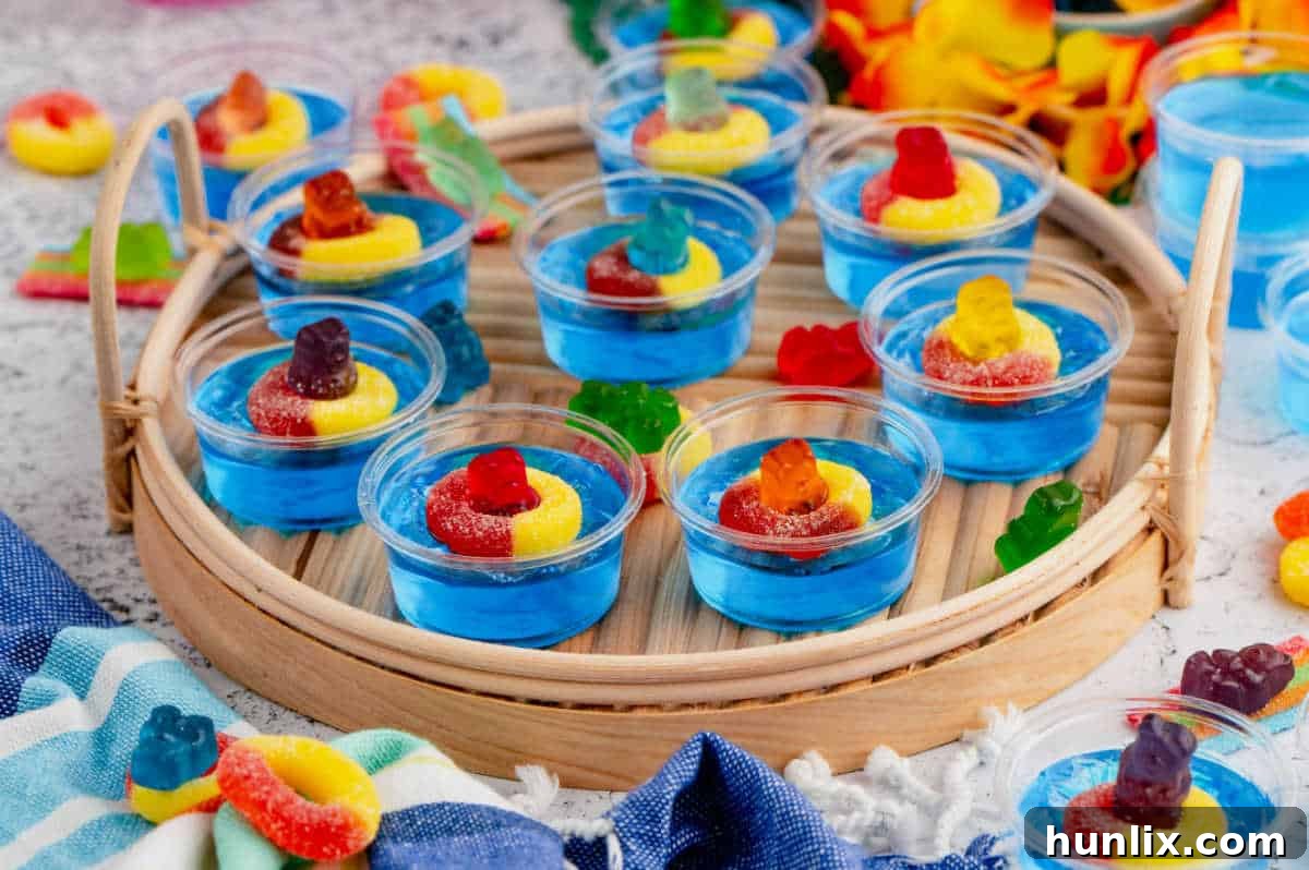Beautifully arranged Pool Party Jello Shots on a rustic wooden serving tray, ready for a summer party.