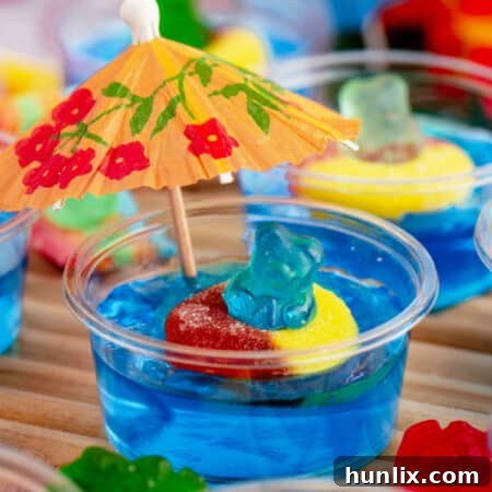 The finished Pool Party Jello Shots on a brown surface, ready to be served.