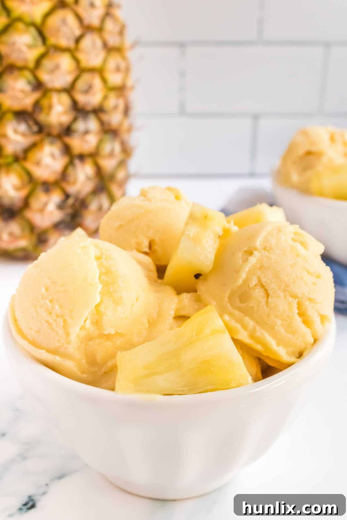 Pineapple ice cream in a bowl.