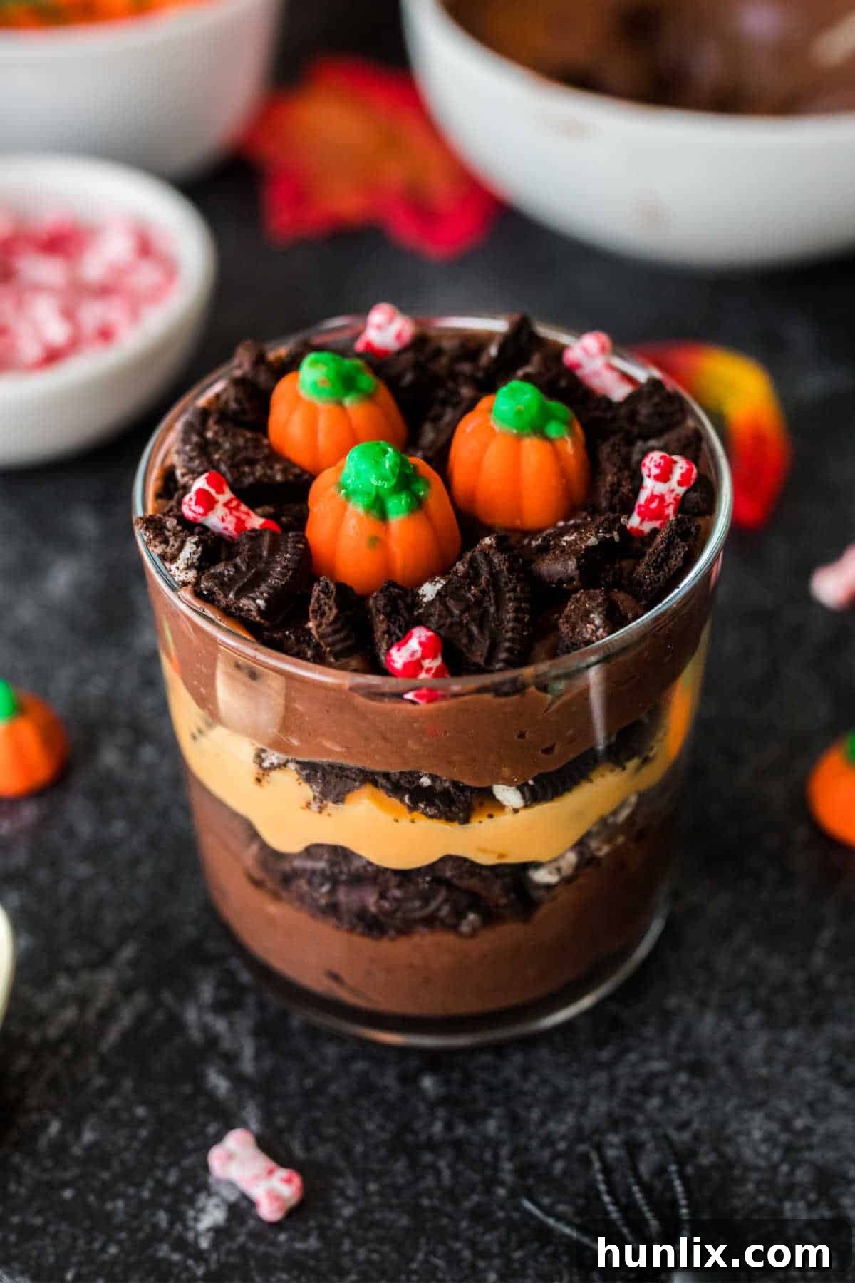 Pumpkin Patch Pudding Pots 2 A pumpkin patch dirt cup on a black surface.