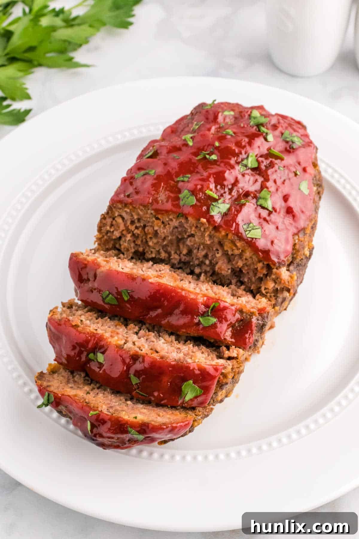 Meatloaf on a platter, ready to be served, highlighting its golden-brown crust and inviting texture.