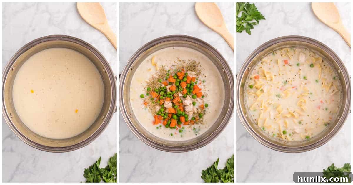 A large pot filled with creamy chicken noodle soup, complete with noodles, chicken, and vegetables, ready to be served.