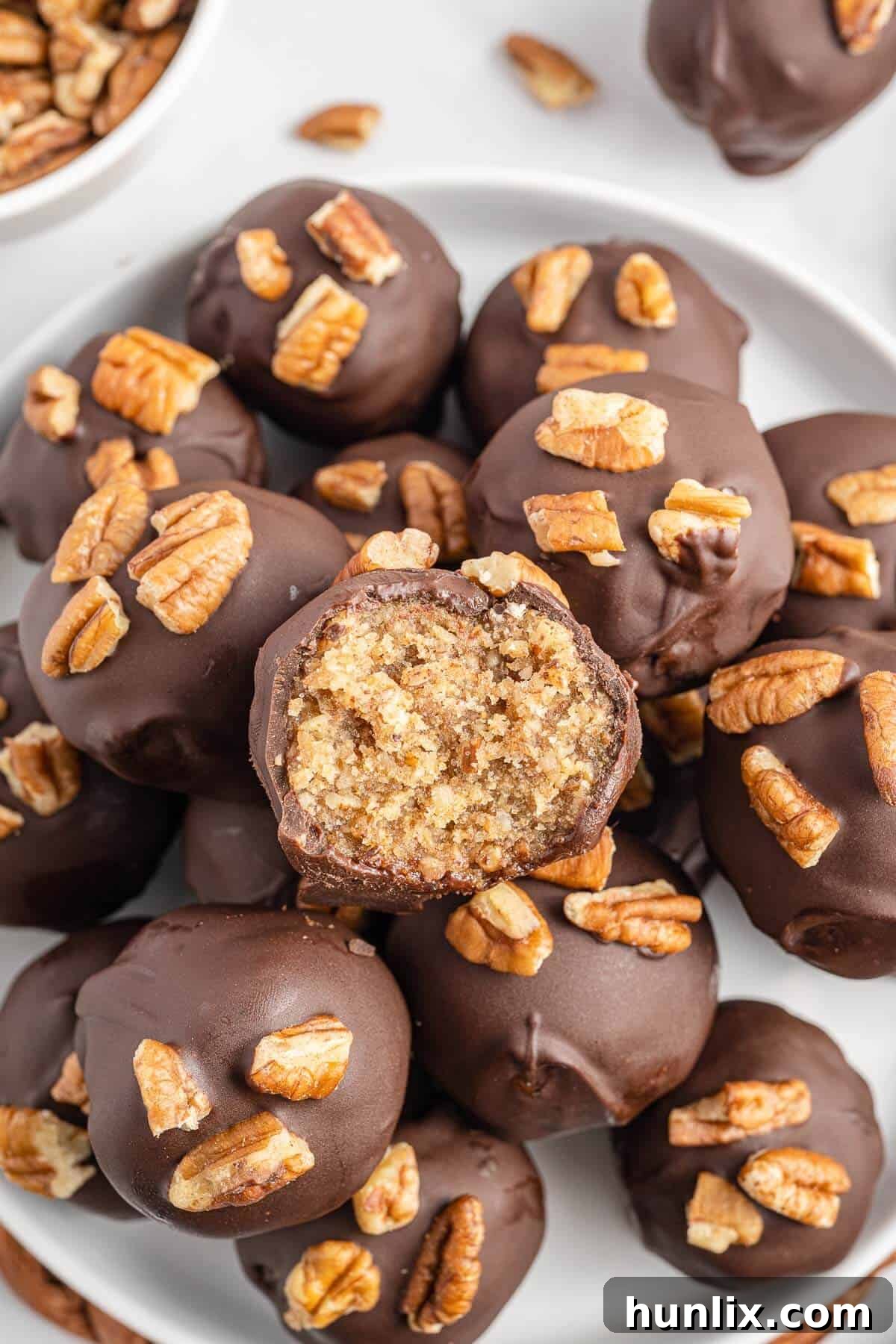 Pecan Pie Truffles 9 A pecan pie ball with a bite taken out, revealing its rich, chewy interior.