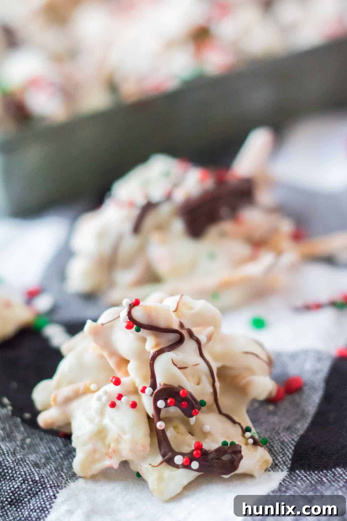 Festive peppermint crockpot candy clusters arranged elegantly on a black and white napkin, ready for holiday gifting and entertaining.