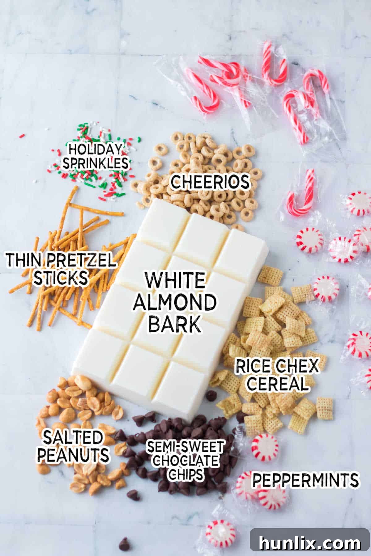 Neatly arranged ingredients for peppermint crockpot candy on a pristine white marble background.