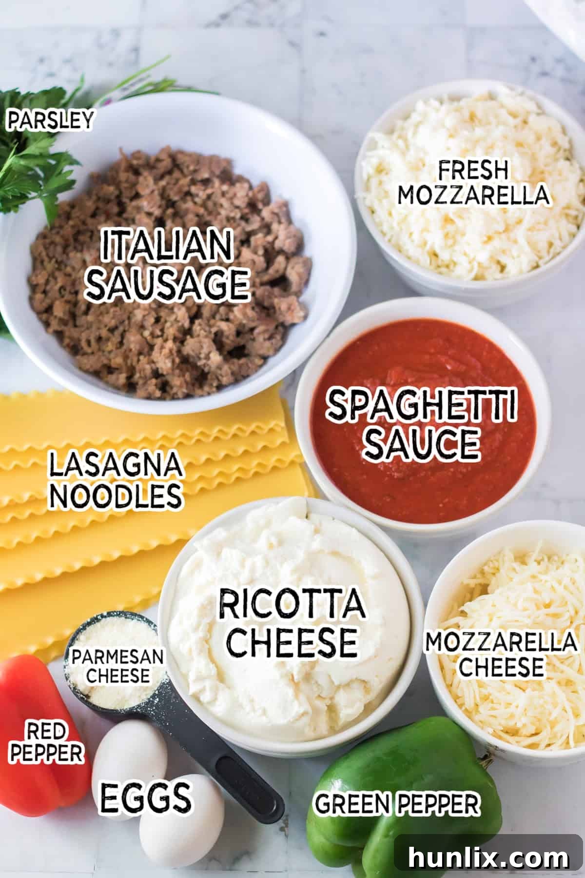 Festive Lasagna Delight 3 Ingredients for making Christmas lasagna, including Italian sausage, pasta sauce, various cheeses, lasagna noodles, and red and green peppers.