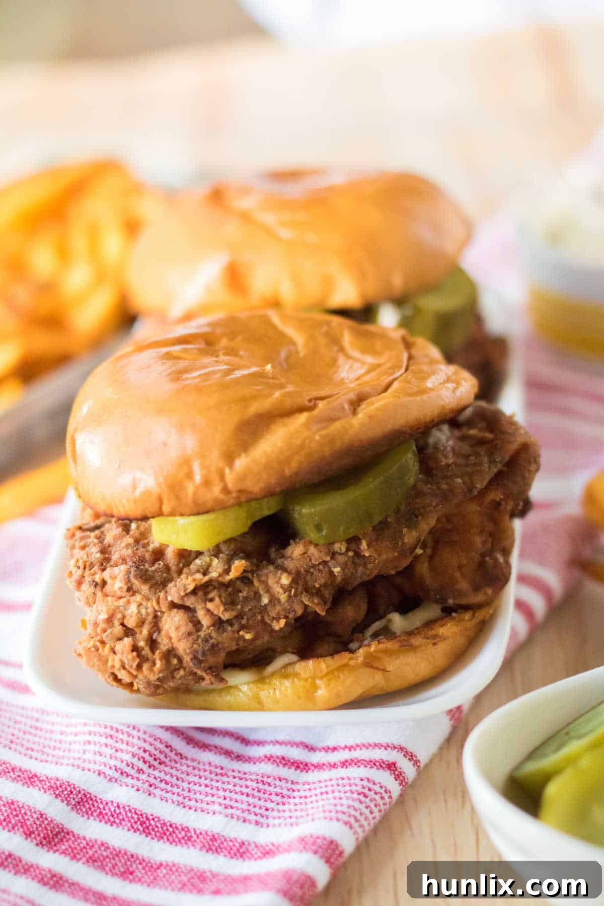 Homemade Popeyes Chicken Sandwich 2 Copycat Popeye's Chicken Sandwiches on a platter.