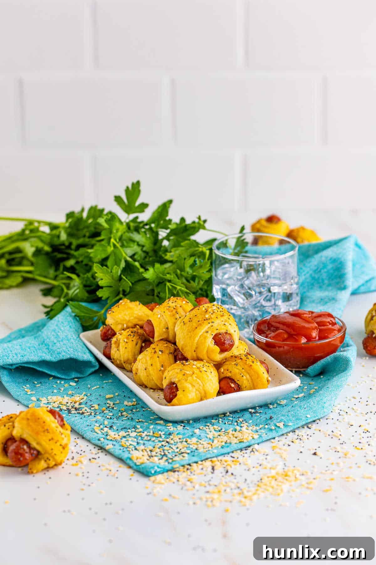 Snuggle Sausages 2 Pigs in a blanket on a platter.