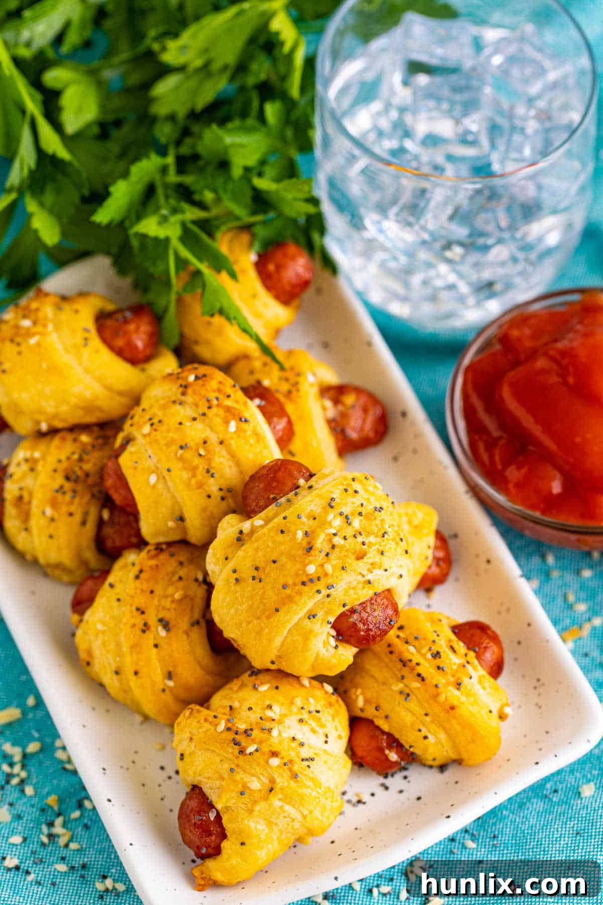 Snuggle Sausages 8 Pigs in a blanket on a platter.