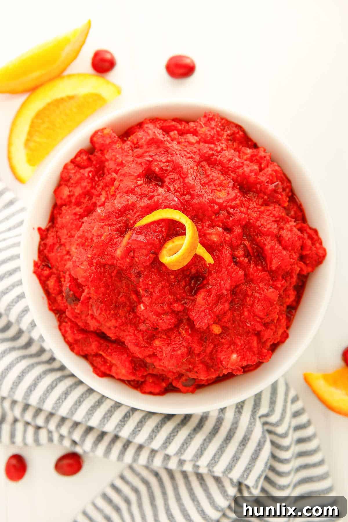 A white bowl brimming with fresh cranberry relish, ready to be served.