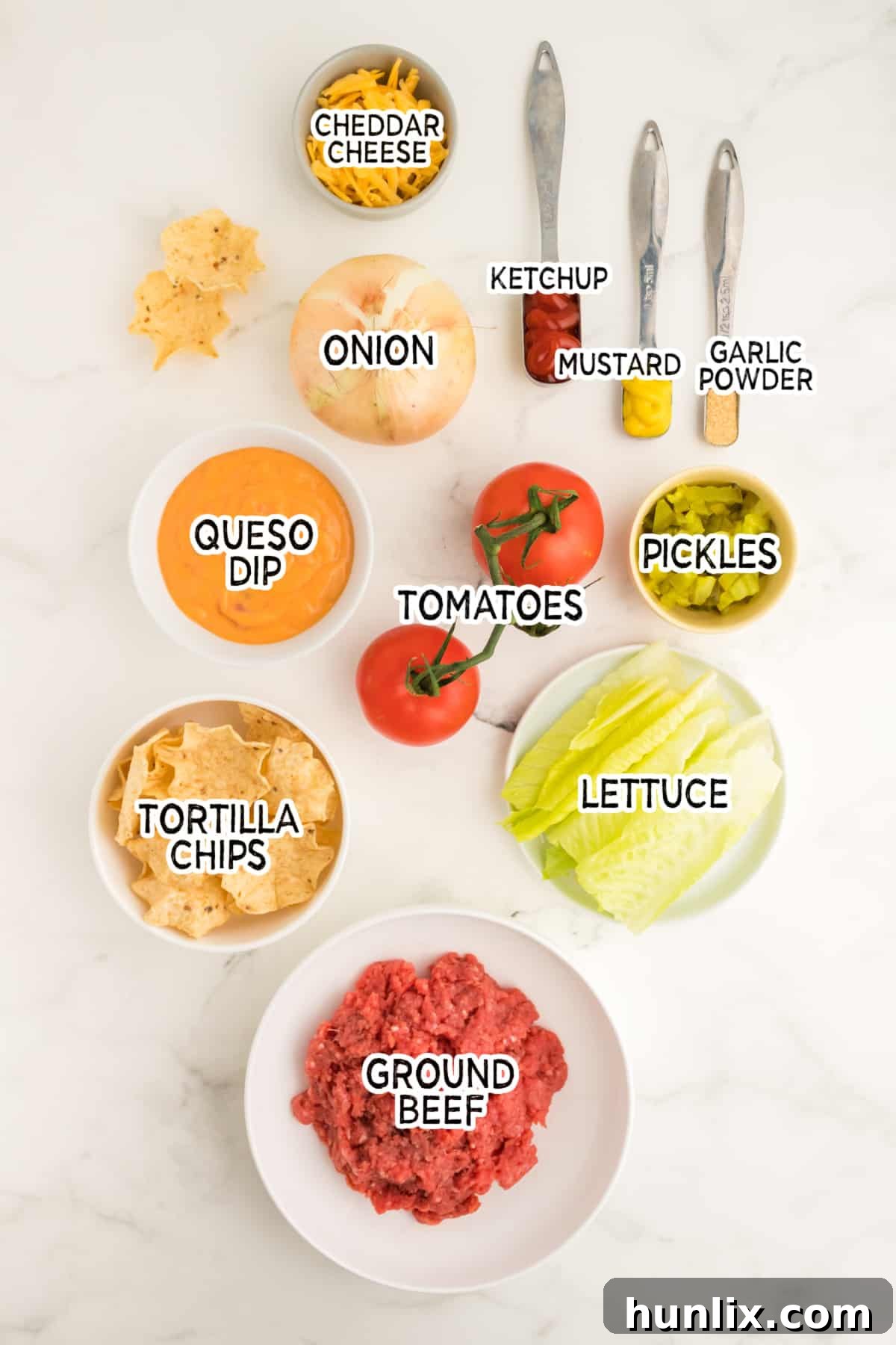 A selection of fresh ingredients laid out on a cutting board, ready to be prepared for the cheeseburger dip recipe.