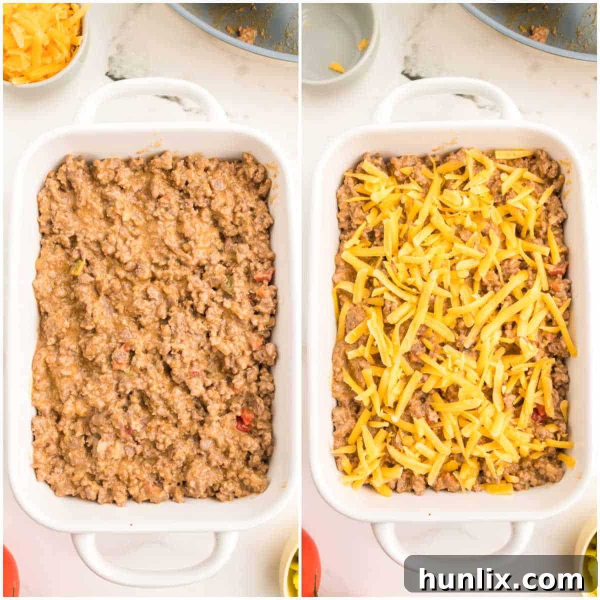 A baking dish filled with cheeseburger dip mixture, topped with the remaining cheddar cheese, ready for broiling.
