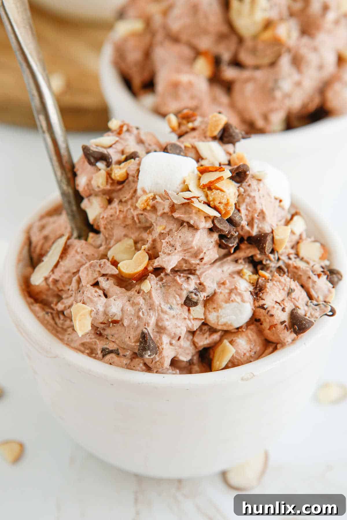 Decadent Rocky Road Dream 2 A bowl of delicious Rocky Road Fluff dessert, garnished with marshmallows and chocolate chips.