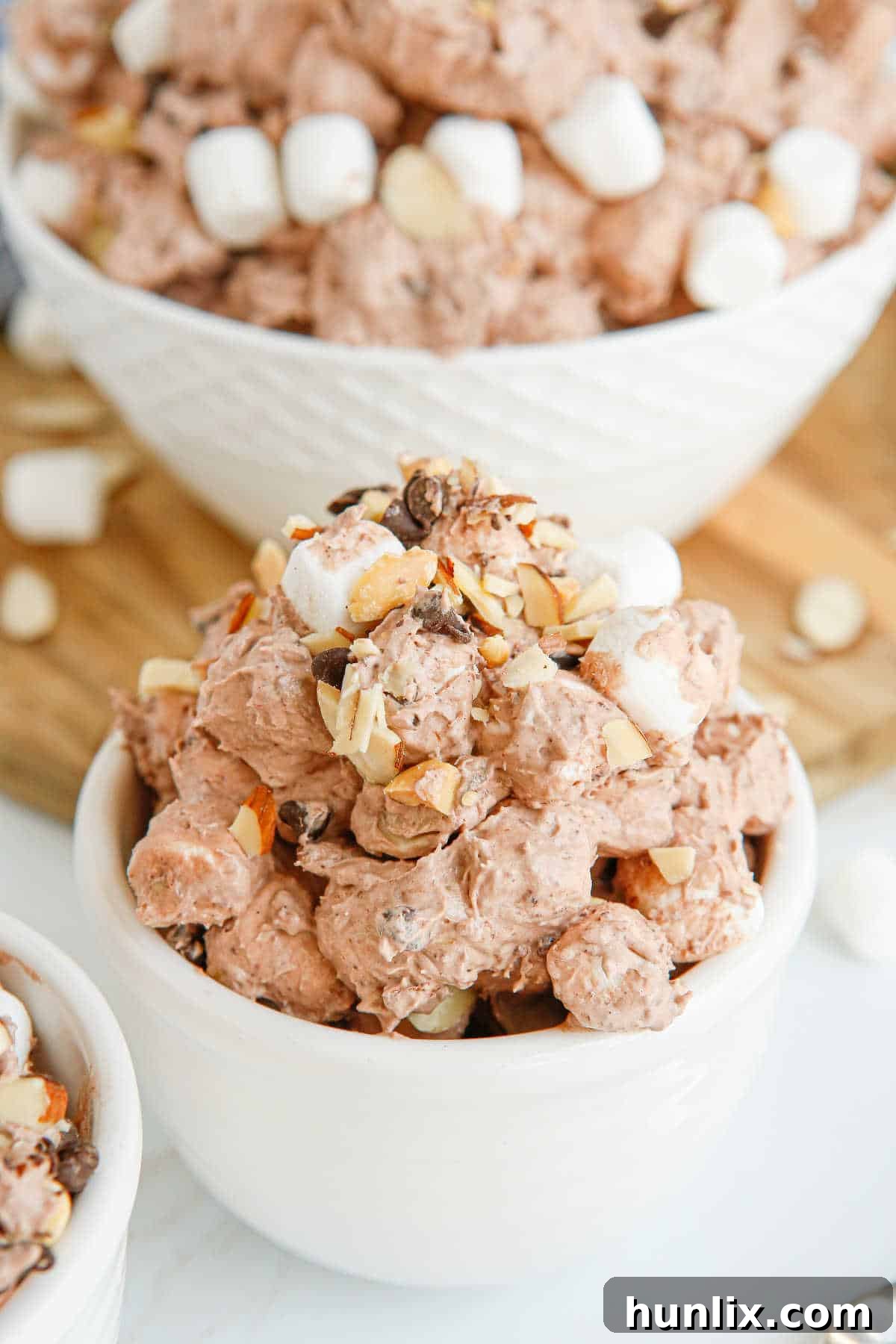 Decadent Rocky Road Dream 7 A close-up of Rocky Road Fluff in a serving bowl, highlighting the creamy texture and individual pieces of marshmallows and nuts.