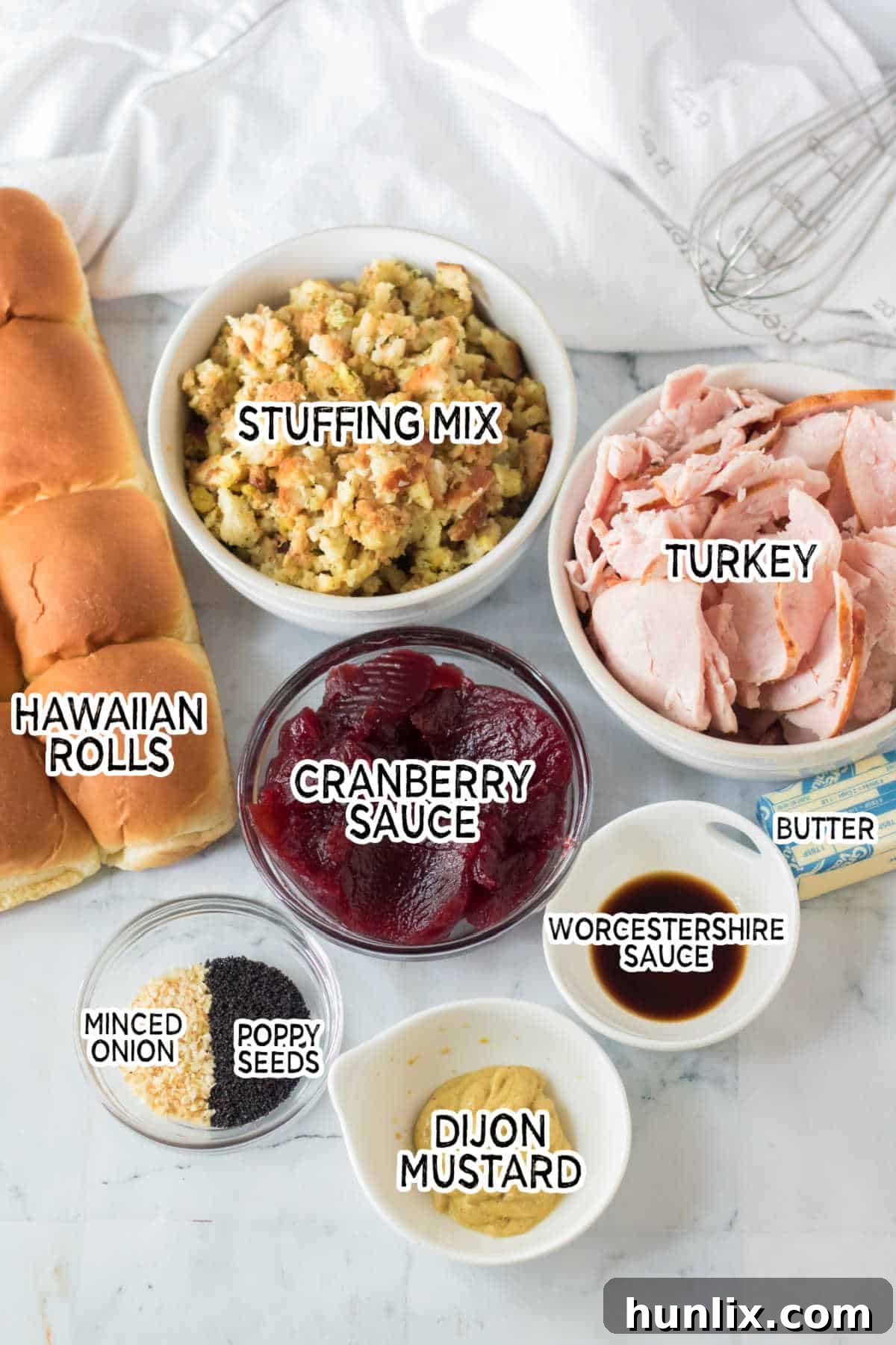 A selection of ingredients laid out, including Hawaiian rolls, turkey, stuffing, and cranberry sauce, ready for Thanksgiving sliders.