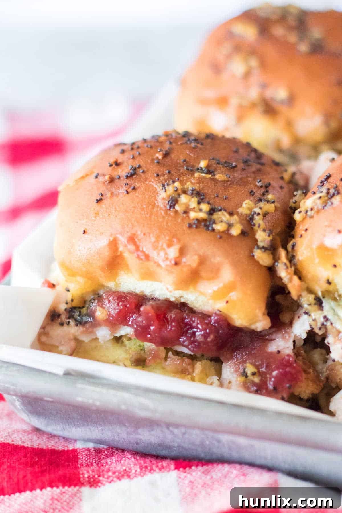 Thanksgiving sliders arranged neatly on a baking sheet, showcasing their golden tops.