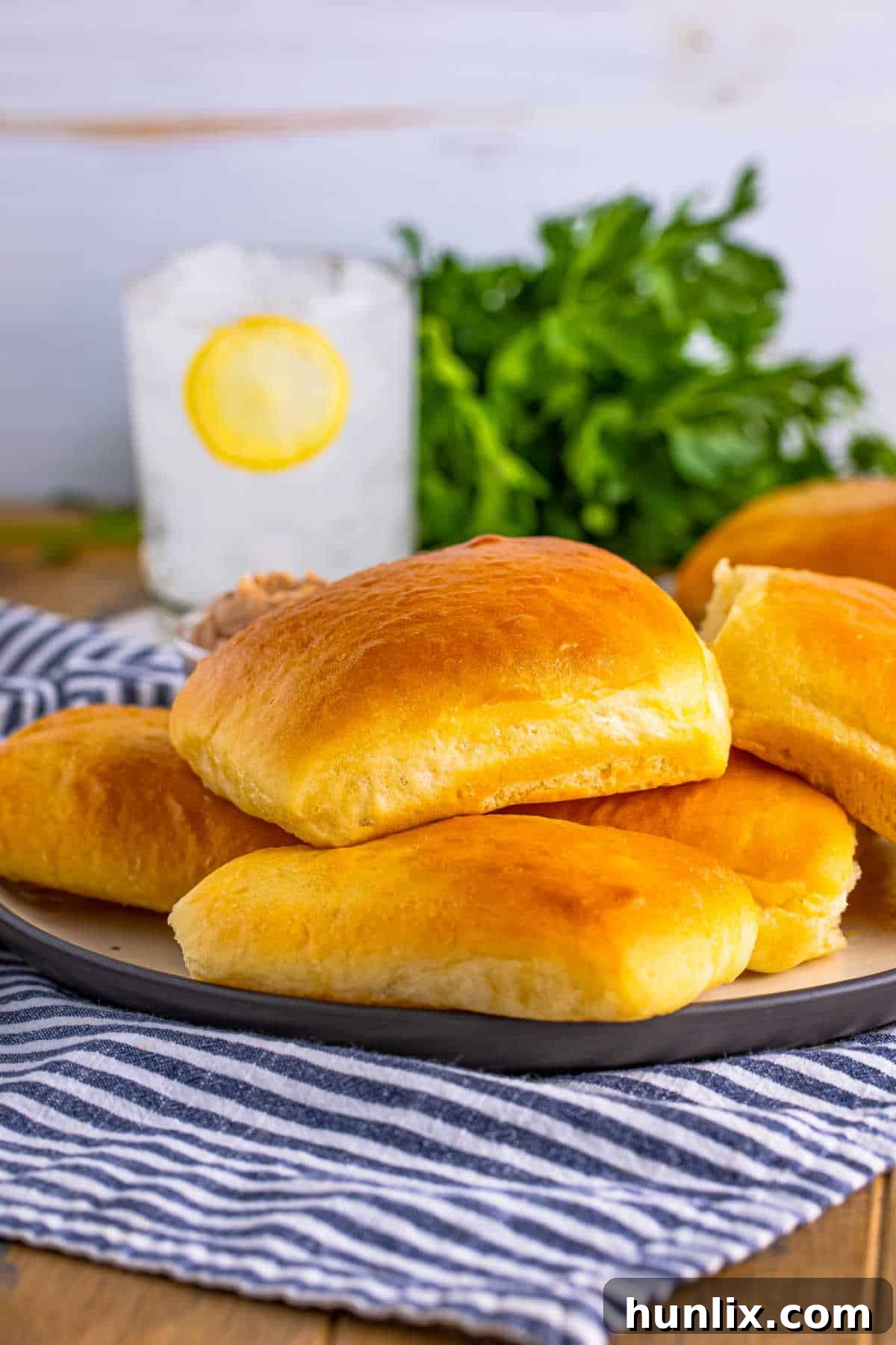 A pile of golden-brown, soft Texas Roadhouse rolls, ready to be served.