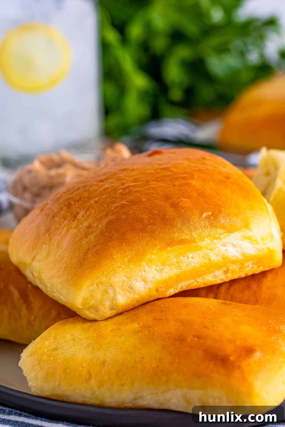 A large pile of soft, golden-brown Texas Roadhouse rolls, ready to be enjoyed.