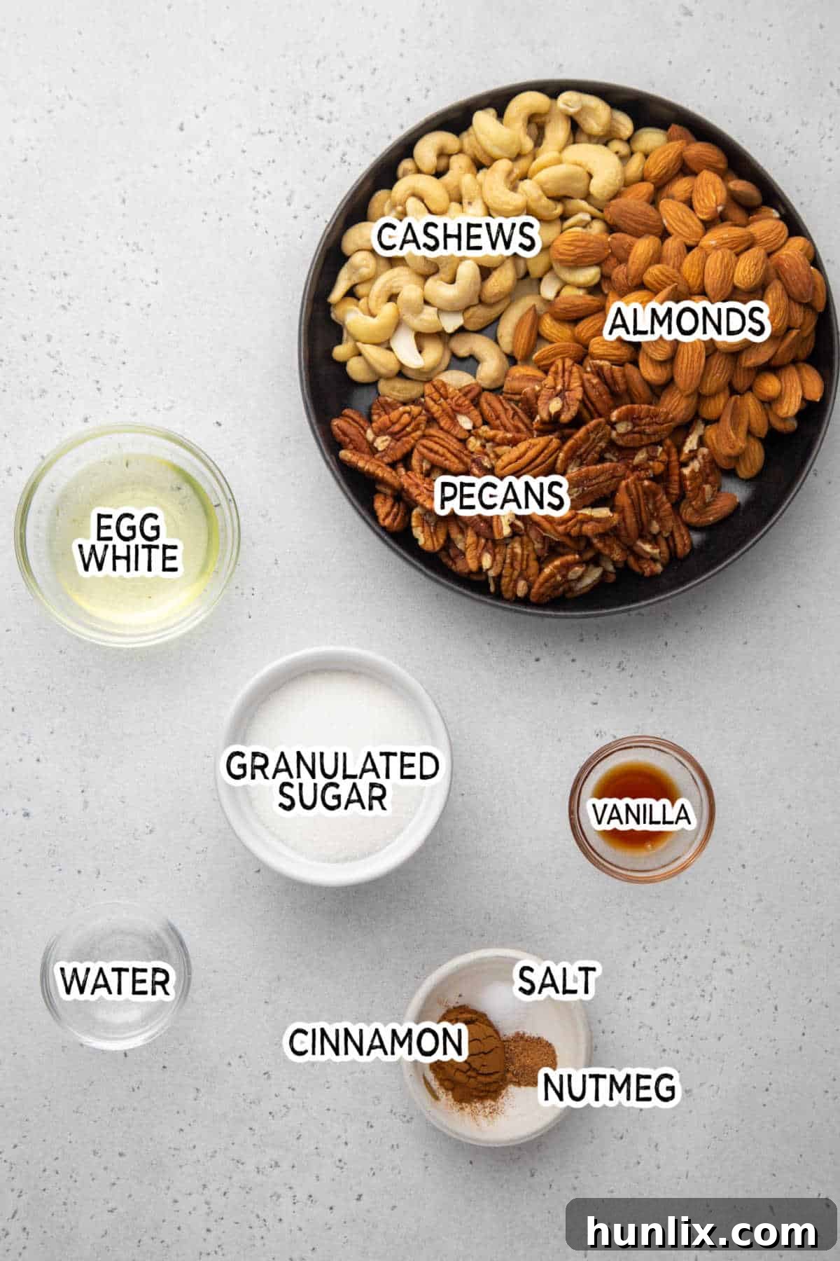 Ingredients for Crockpot Candied Nuts laid out on a surface.