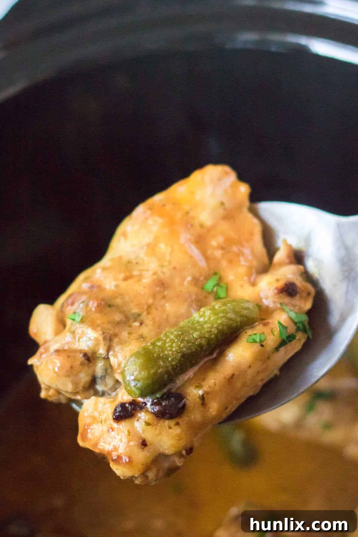 Dill Pickle Slow Cooker Chicken 5 Pickle chicken on a serving spoon.