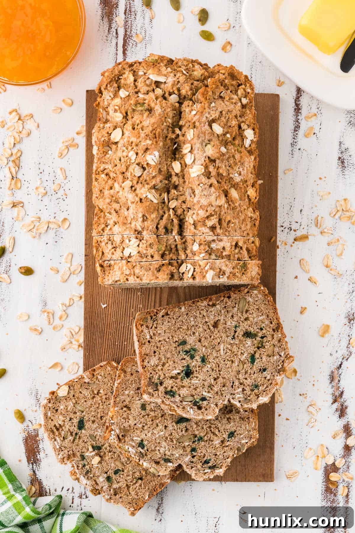 A beautifully baked loaf of Irish brown bread with several slices cut off, revealing its dense texture and wholesome ingredients.