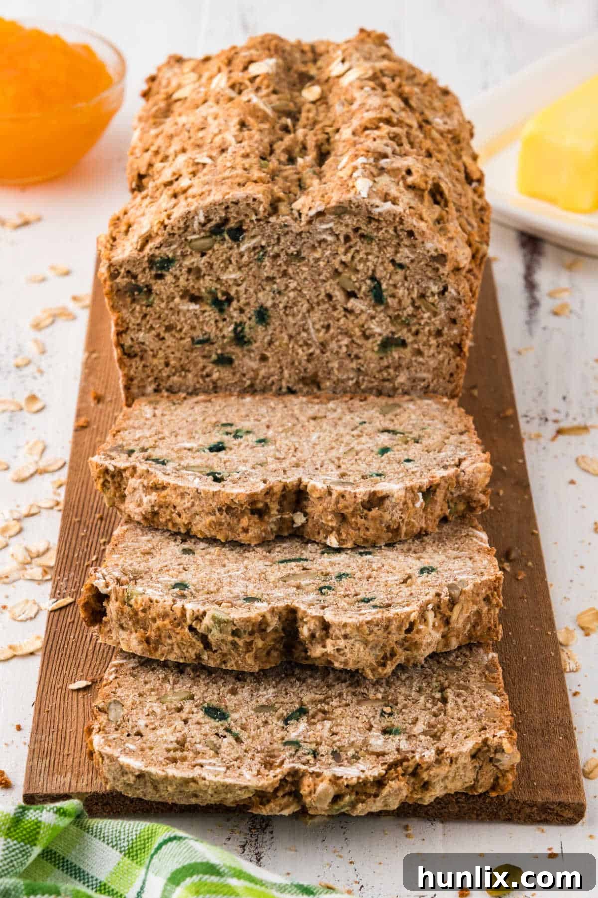 A close-up shot of a baked loaf of Irish brown bread, showcasing its rustic crust and inviting texture, with some slices already cut and ready to serve.