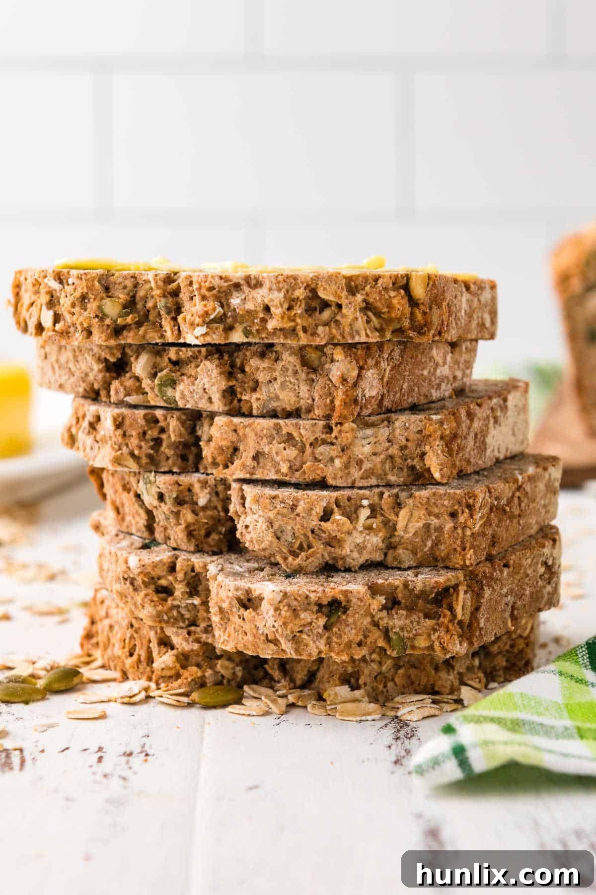 A perfectly arranged stack of freshly baked Irish brown bread slices, showcasing their appealing rustic crust and wholesome interior.