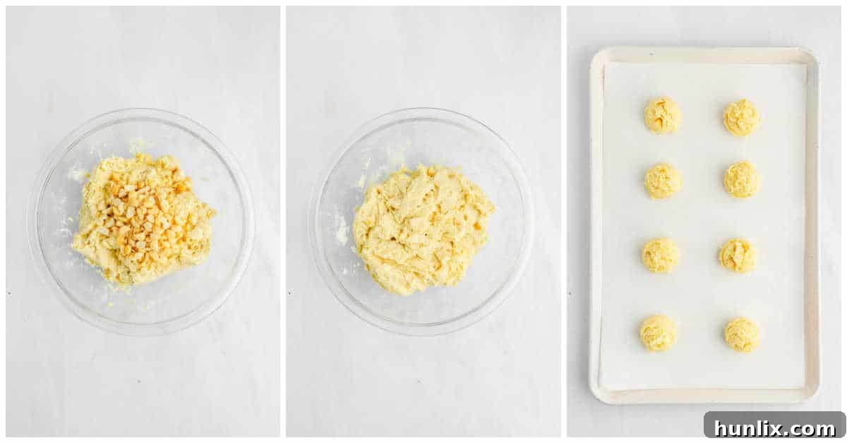 Cookie dough balls on a baking sheet.