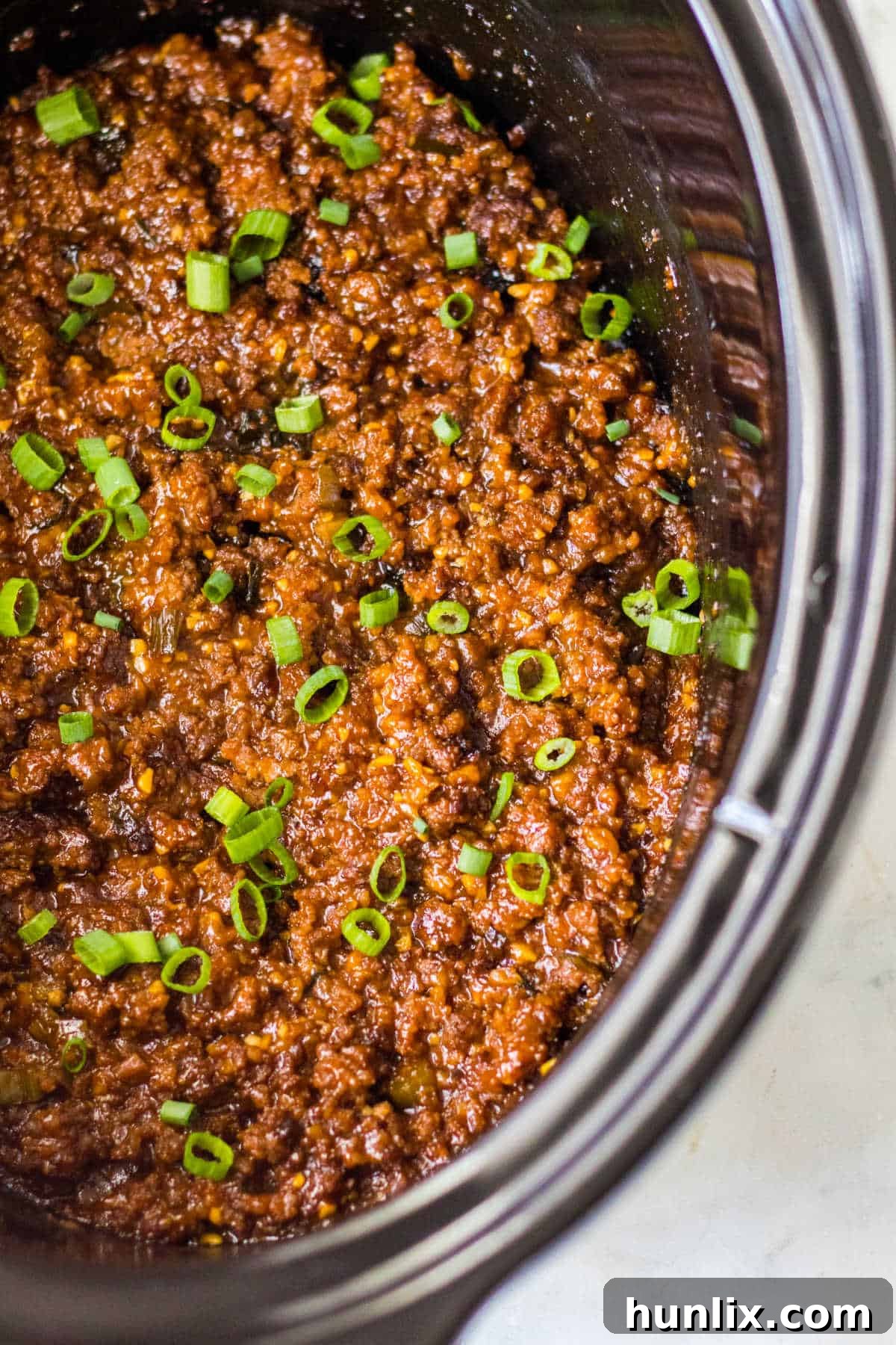 Korean sloppy joe meat in a slow cooker, showing the rich, saucy texture.