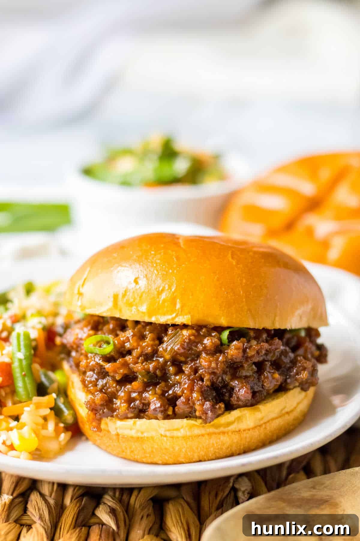 A single Korean sloppy joe on a white plate, showcasing the hearty filling.