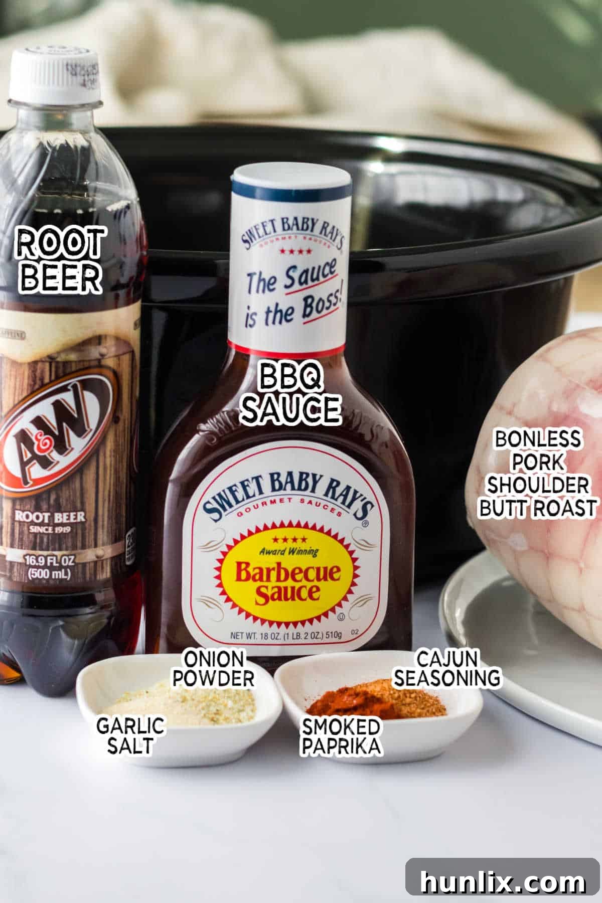 A vibrant flat lay of all the fresh and packaged ingredients needed to make delicious root beer pulled pork.