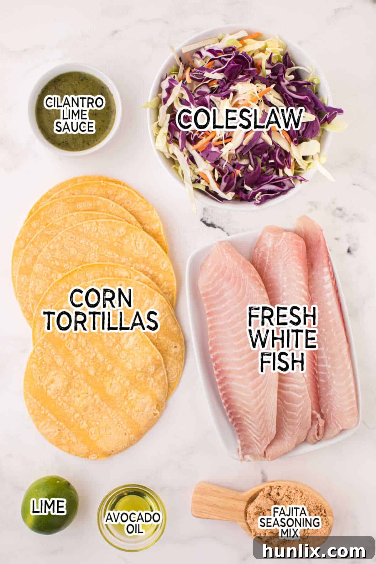 A flat lay photograph showcasing all the fresh ingredients needed to make delicious fish tacos.