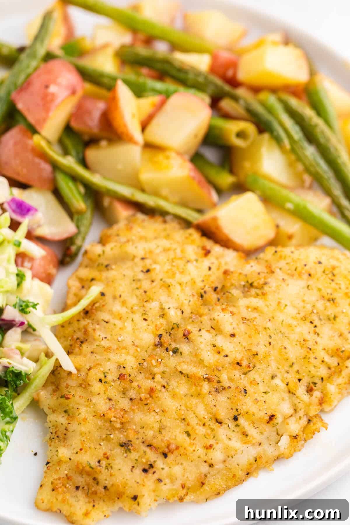 A close-up shot of the cooked lemon pepper sole fillet and roasted vegetables on a plate, highlighting the delicious textures and golden-brown perfection.
