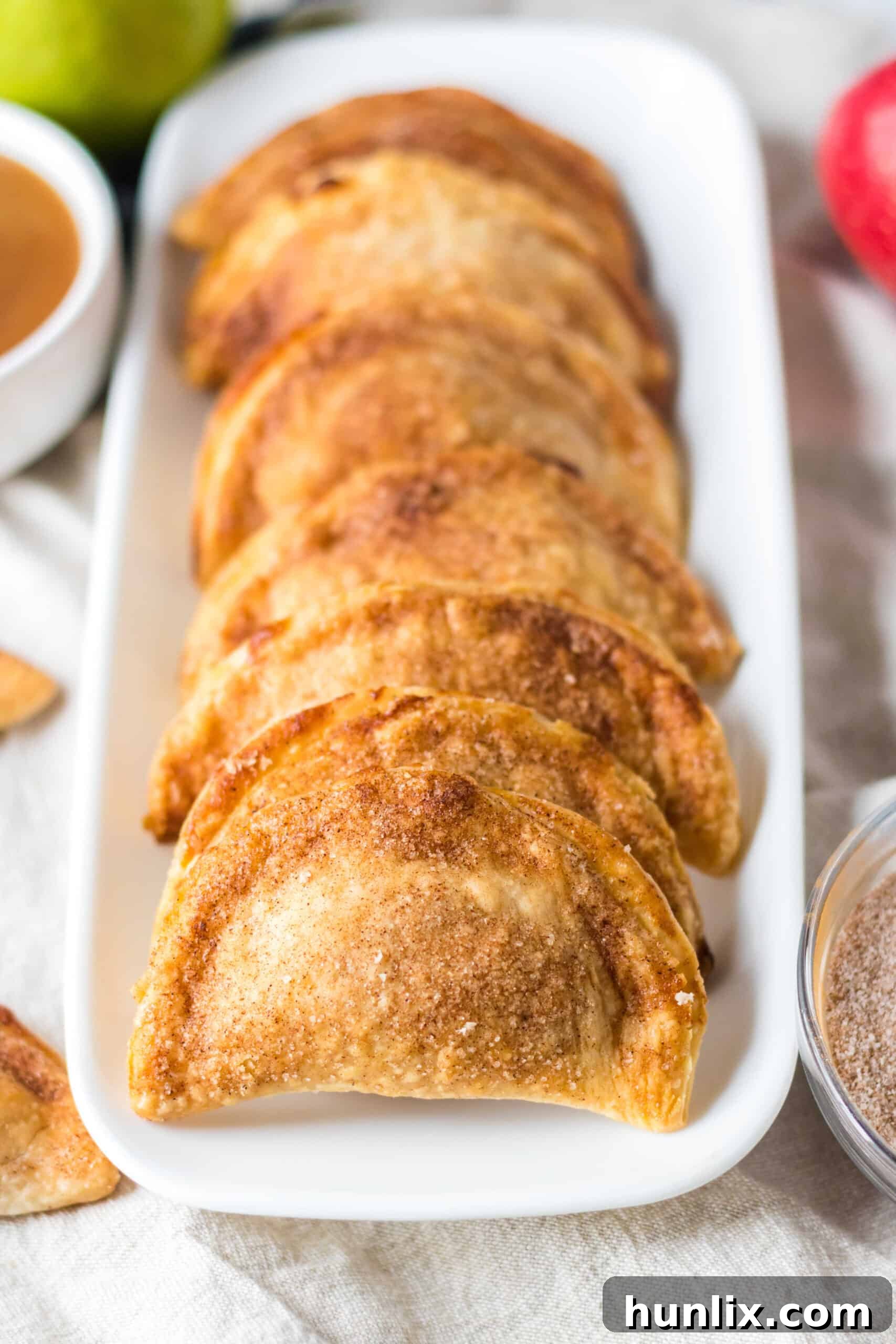 Freshly air-fried Copycat Taco Bell Air Fryer Caramel Apple Empanadas arranged beautifully on a platter, ready to be served.