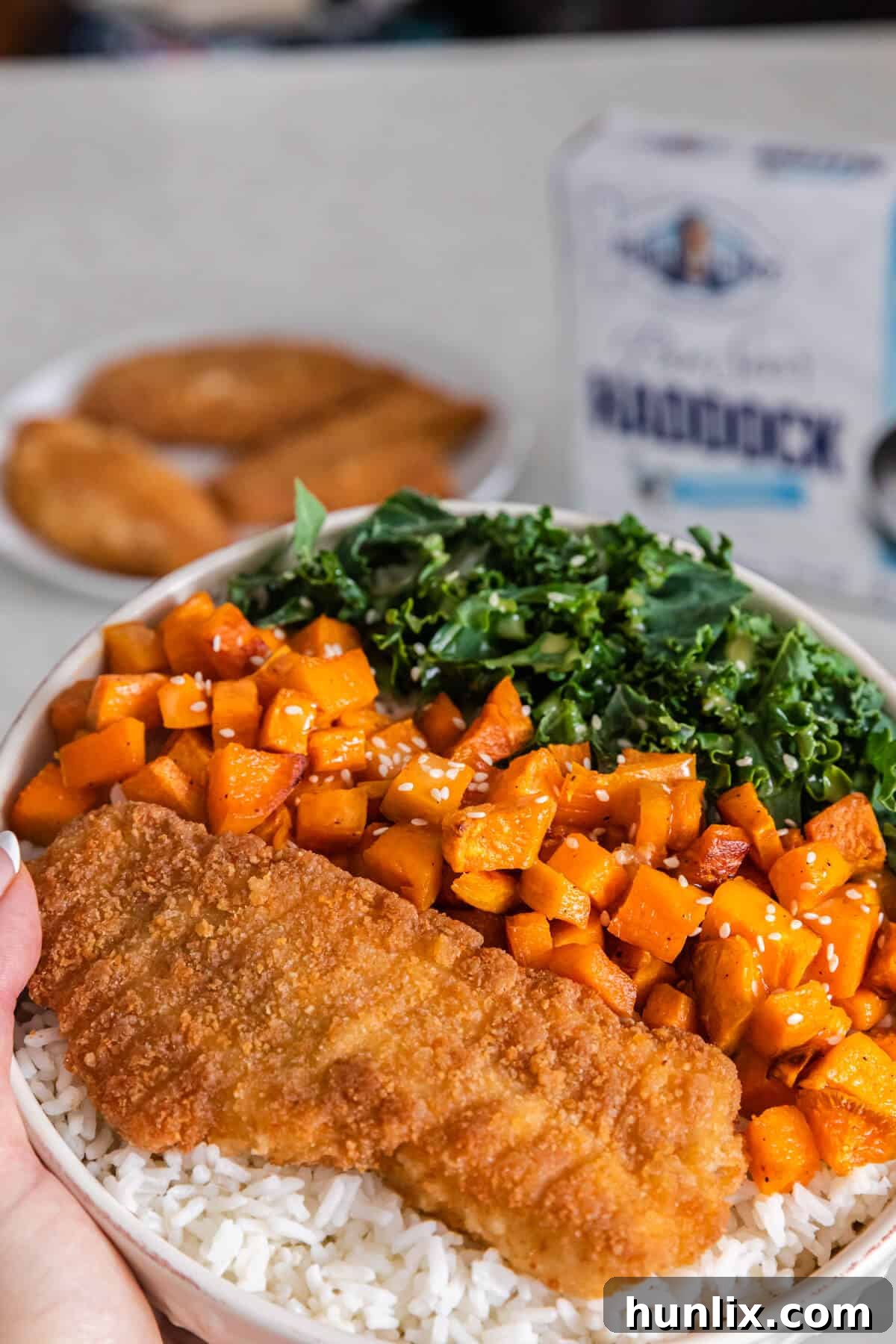 5 Daily Practices for a Vibrant Life 2 Hands holding a haddock buddha bowl.