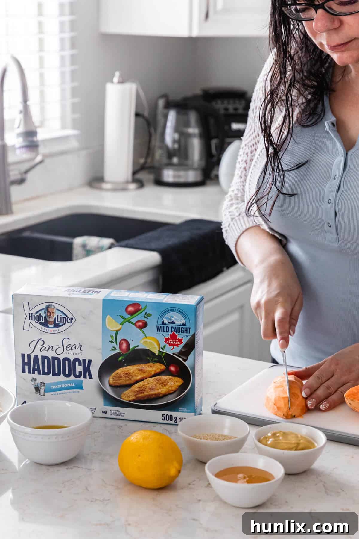 5 Daily Practices for a Vibrant Life 4 A woman preparing a haddock buddha bowl.
