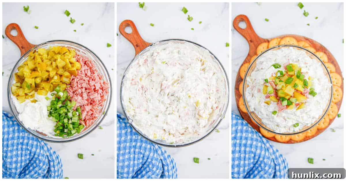 The dill pickle dip, now with all ingredients including diced pickles, ham, and green onions, being mixed thoroughly in a bowl with a spatula, creating a colorful and textured appetizer.